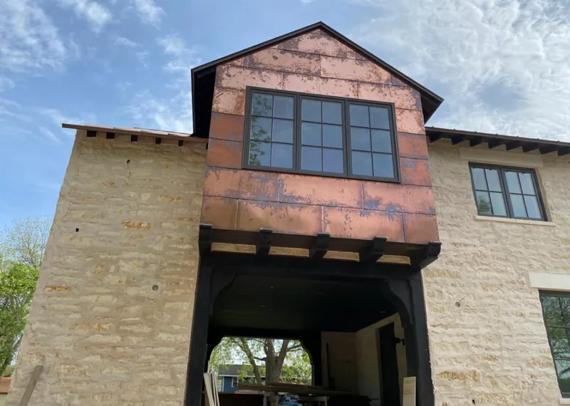 Copper metal panel facade on a stone building for Skylight Installation in Edina