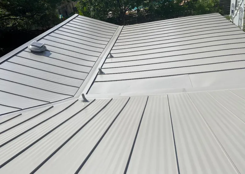 Solar attic fan installed on a metal roof for Roof Ventilation in Edina