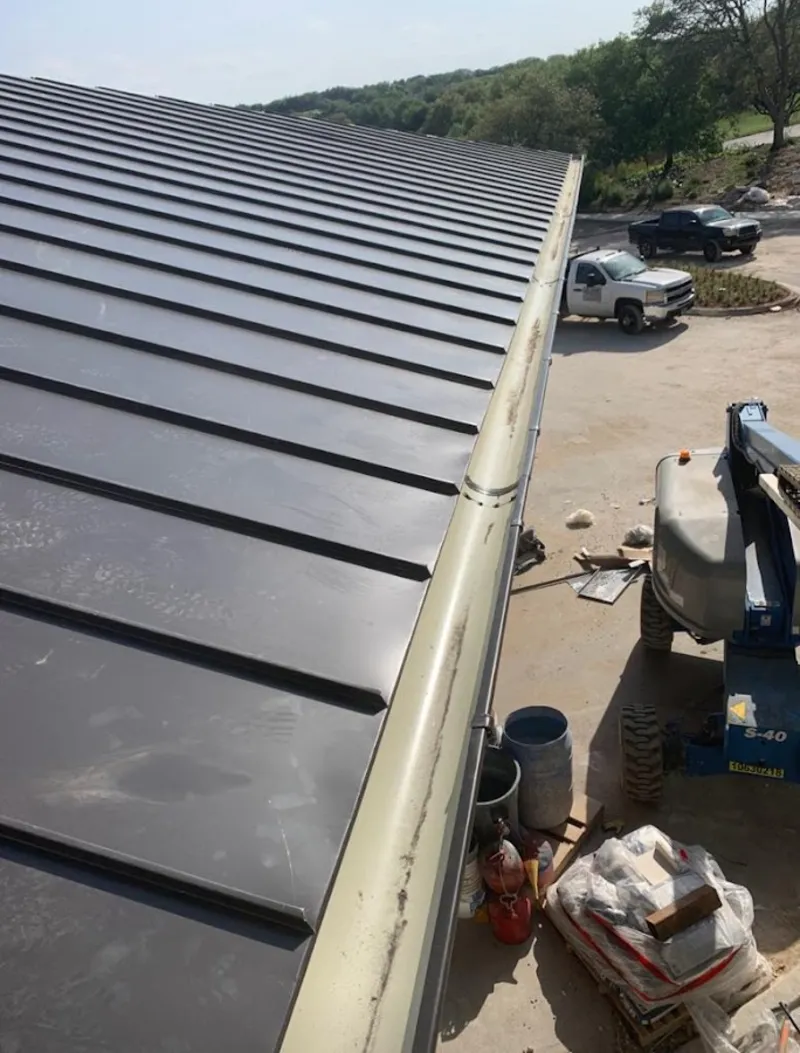 Standing seam panel and gutter detail on a metal roofing jobsite in Edina